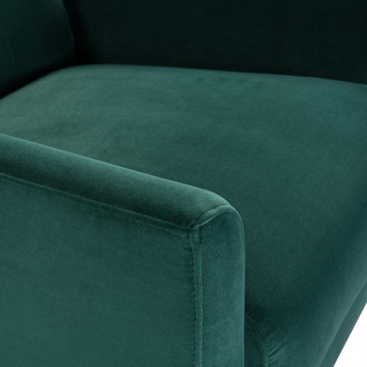 detail of modern button backed armchair upholstered in emerald green velvet