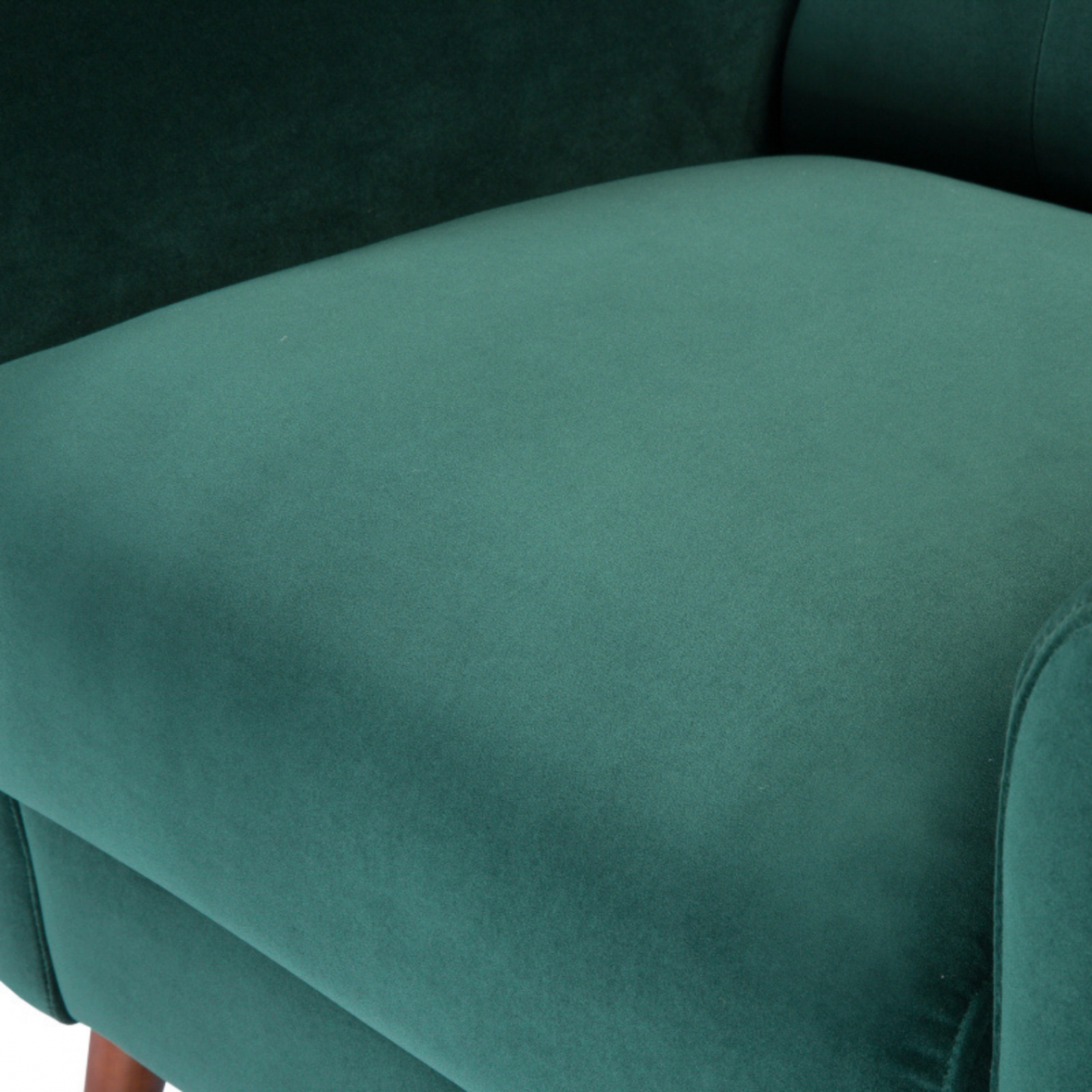 detail of modern button backed armchair upholstered in emerald green velvet