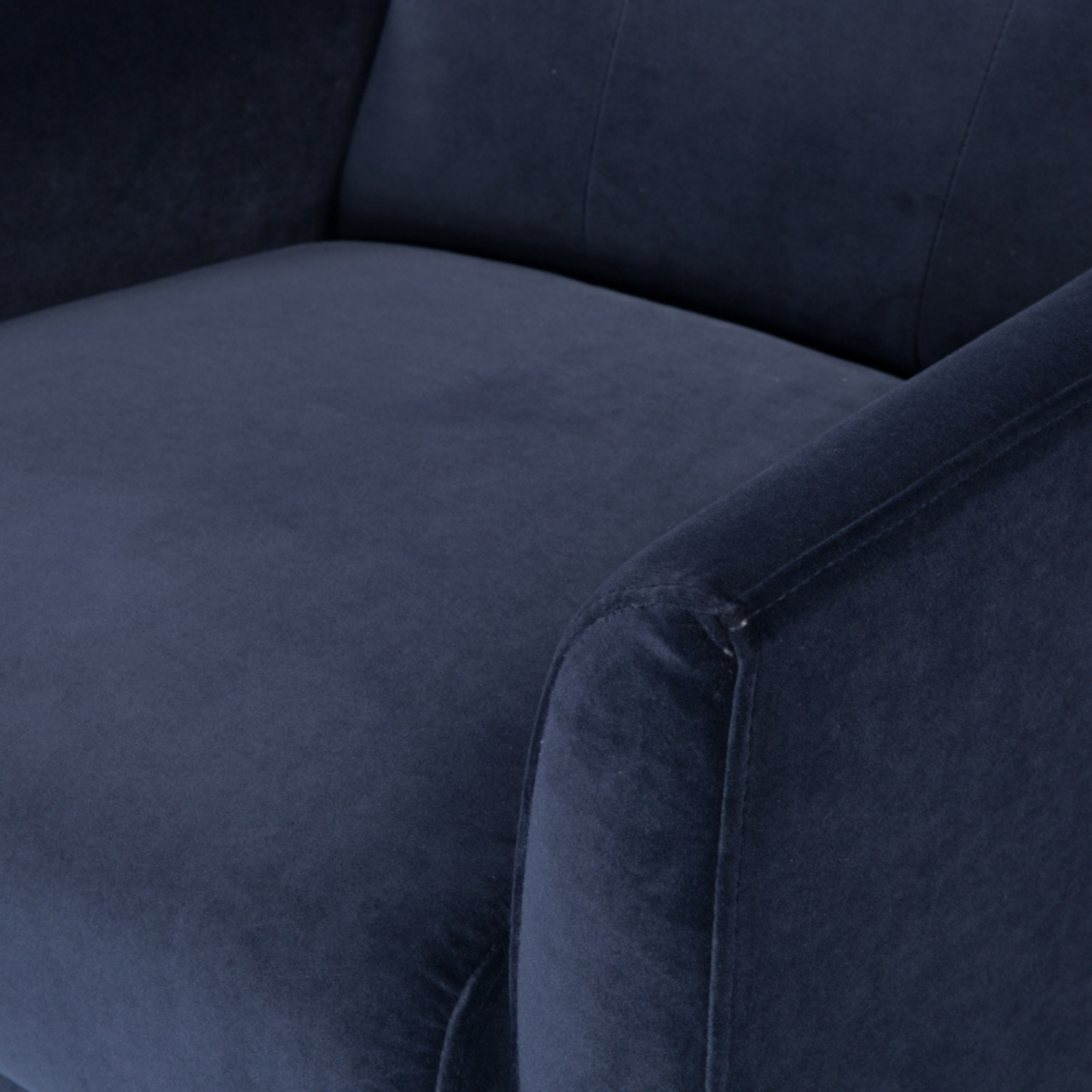 detail of modern button backed armchair upholstered in midnight blue velvet