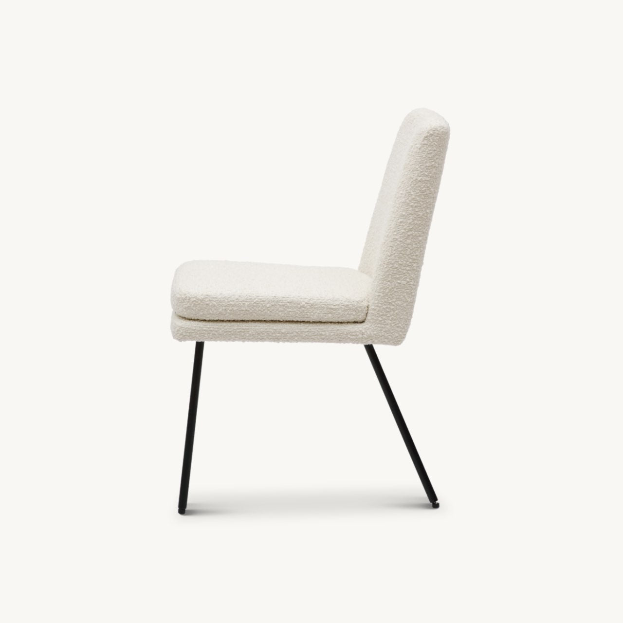 comfortable, fully upholstered minimal dining chair in ivory boucle fabric