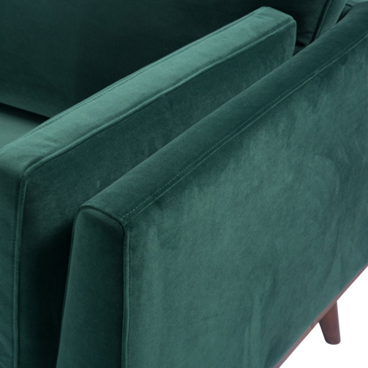 detail of simple modern 3 seater sofa in emerald green velvet